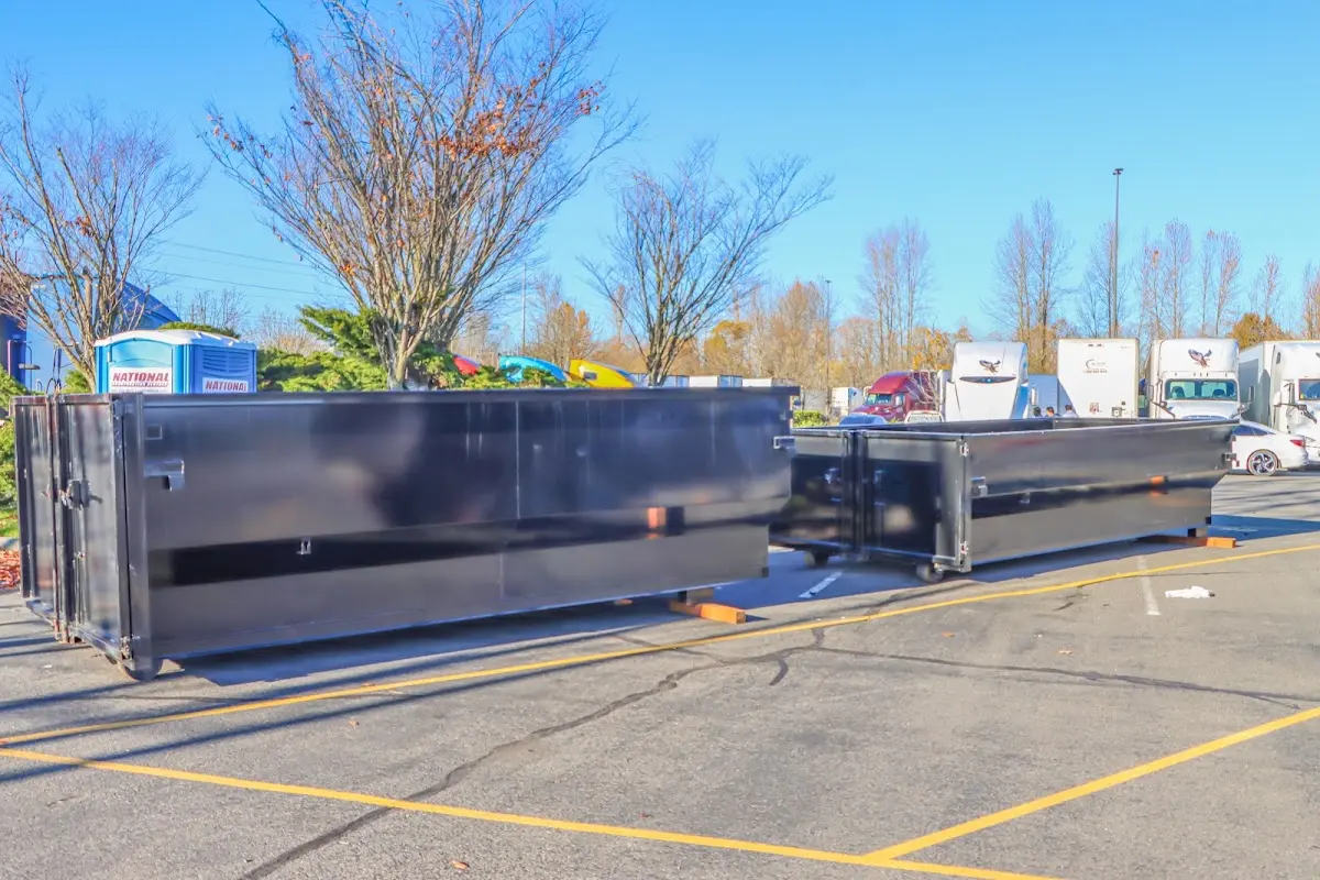 Professional dumpster rental service with roll-off container on residential driveway in Celina